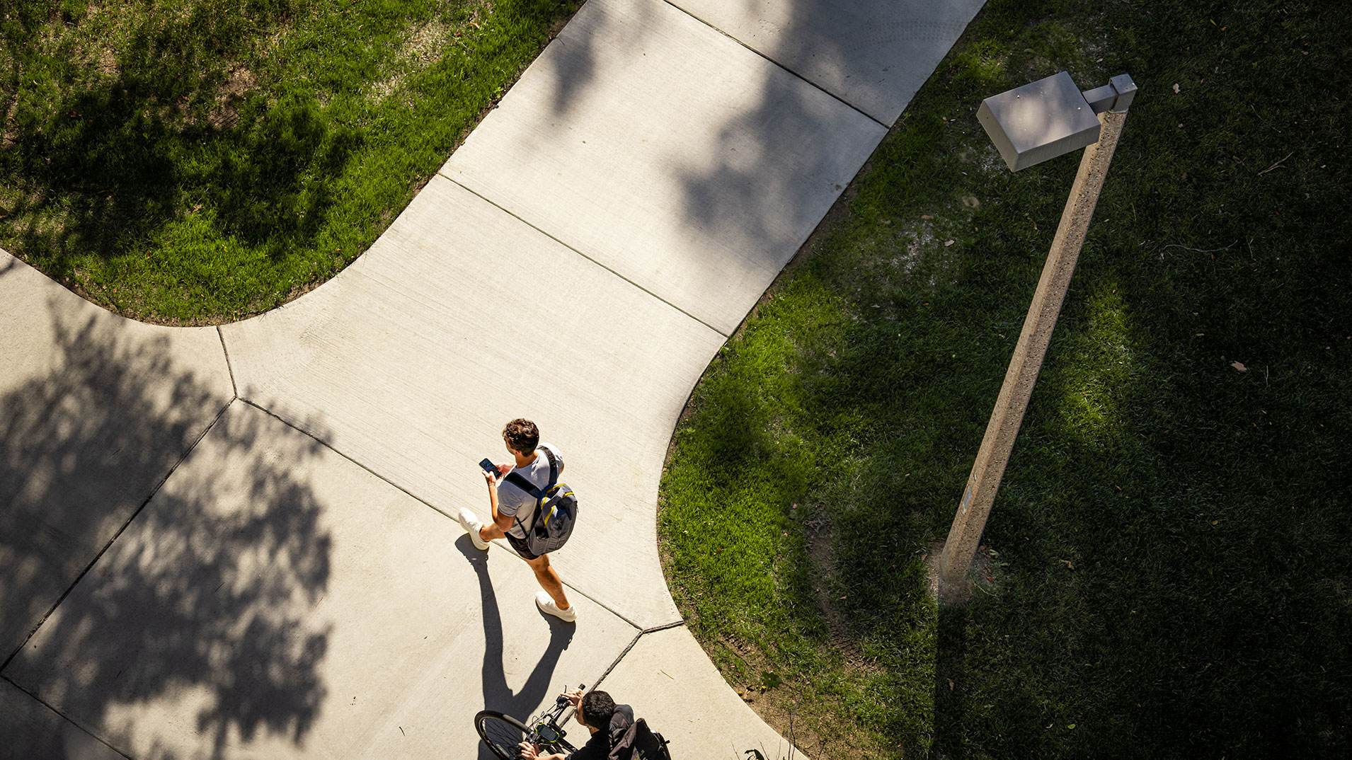 Student walking on sidewalk intersection