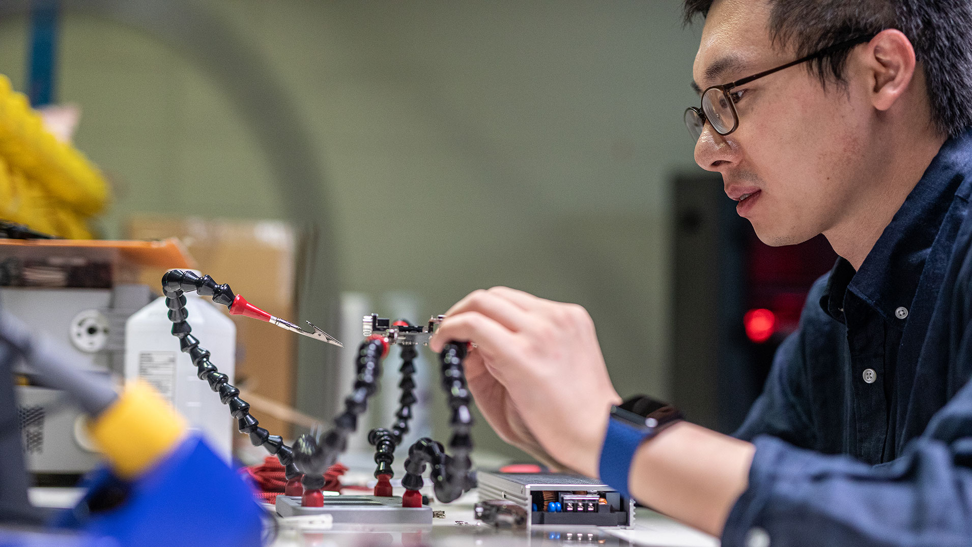 MSU Student working on a mechanical part for a car