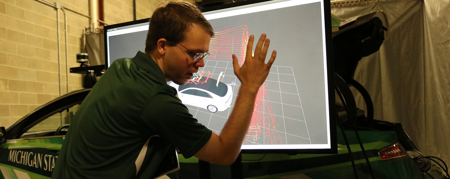 Graduate student looking at a 3D model of a car