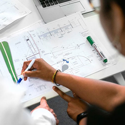 Close-up of people working on a chart plan for a DAM